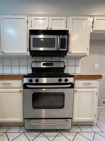 a view of a hallway with a sink and a mirror