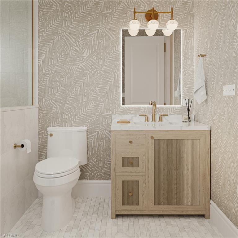 335 Burning Tree Drive Naples, FL 34105 - Photo 13 of 27 Half bath featuring vanity and light tile patterned flooring