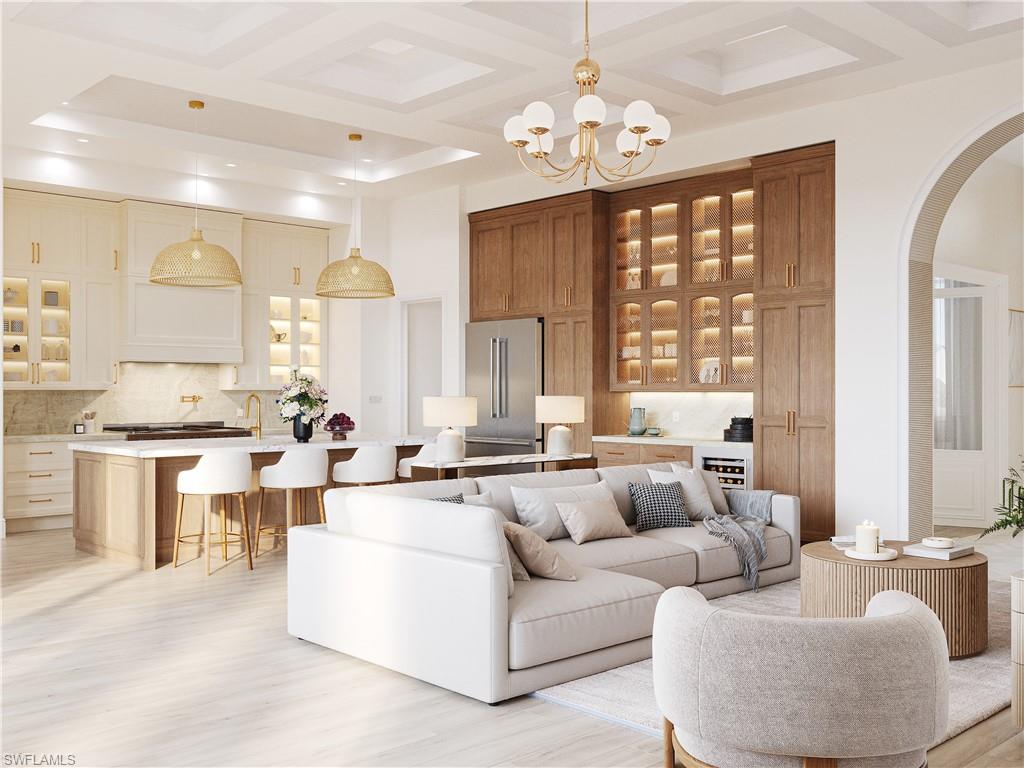 335 Burning Tree Drive Naples, FL 34105 - Photo 2 of 27 Living area featuring coffered ceiling, arched walkways, light wood finished floors, suspended lighting, and beverage cooler