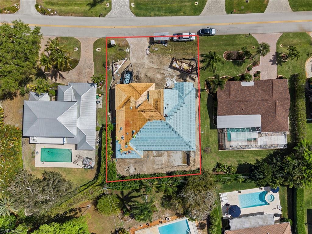 335 Burning Tree Drive Naples, FL 34105 - Photo 23 of 27 Aerial view of property and surrounding area featuring property parcel outlined and a pool