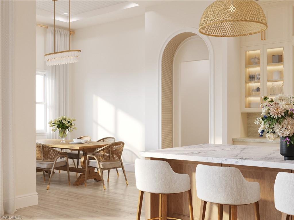 335 Burning Tree Drive Naples, FL 34105 - Photo 5 of 27 Dining room with light wood-style floors and arched walkways
