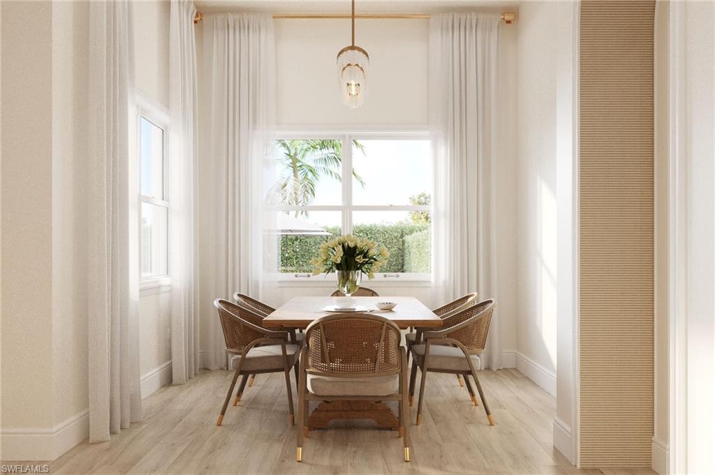 335 Burning Tree Drive Naples, FL 34105 - Photo 6 of 27 Dining area featuring light wood-style floors and a chandelier