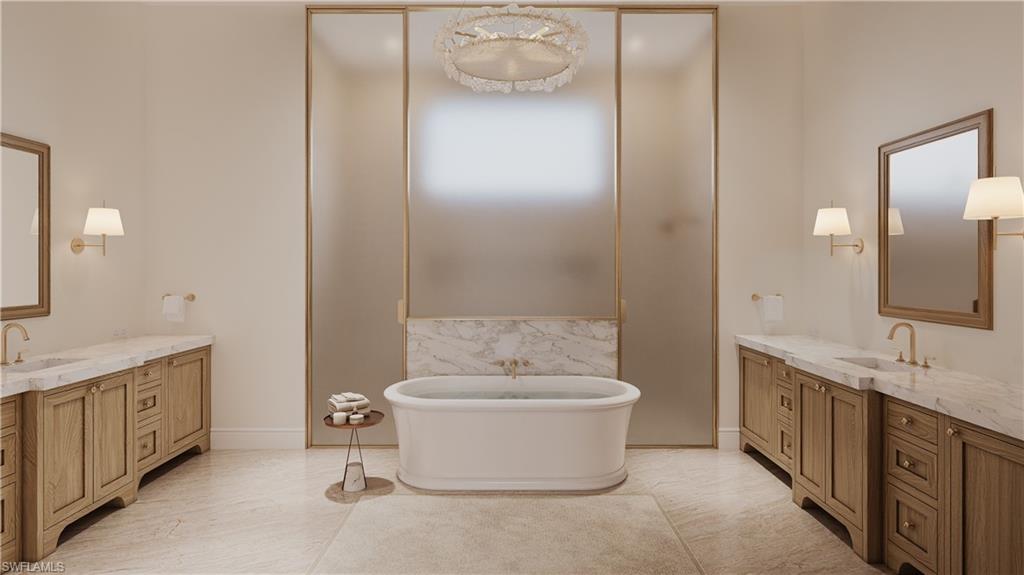 335 Burning Tree Drive Naples, FL 34105 - Photo 10 of 27 Bathroom with two vanities and a freestanding bath