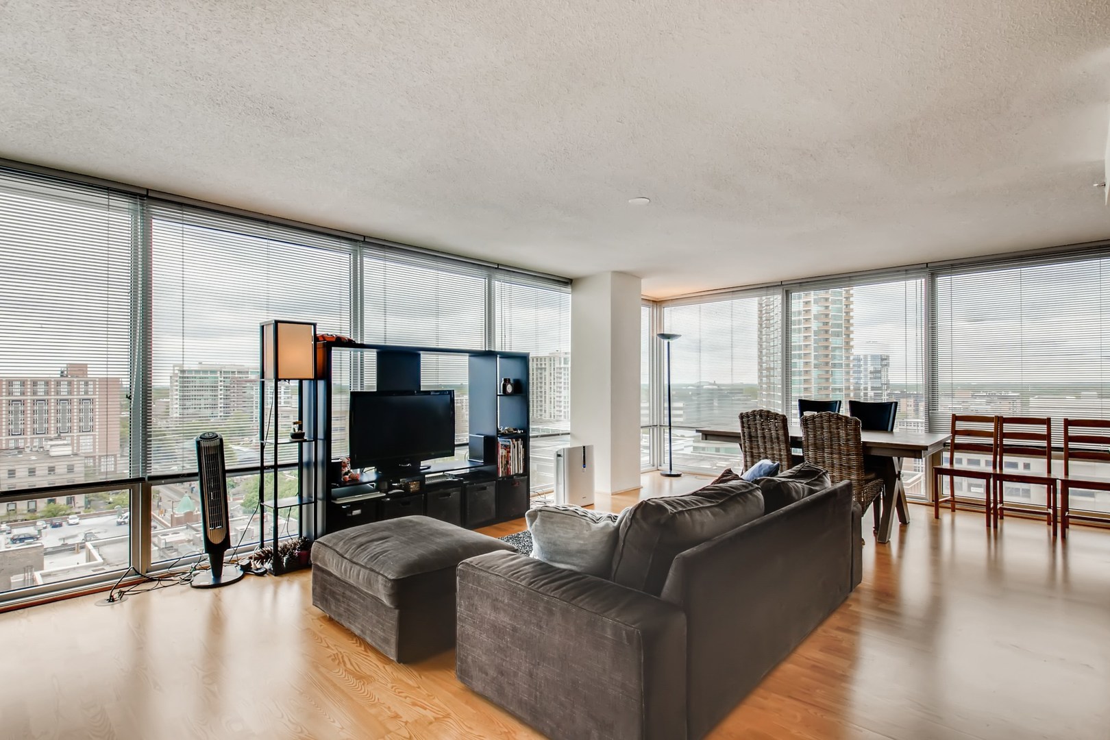 800 Elgin Road, Unit 1421 Evanston, IL 60201 - Photo 2 of 11 a living room with furniture floor to ceiling window and a flat screen tv