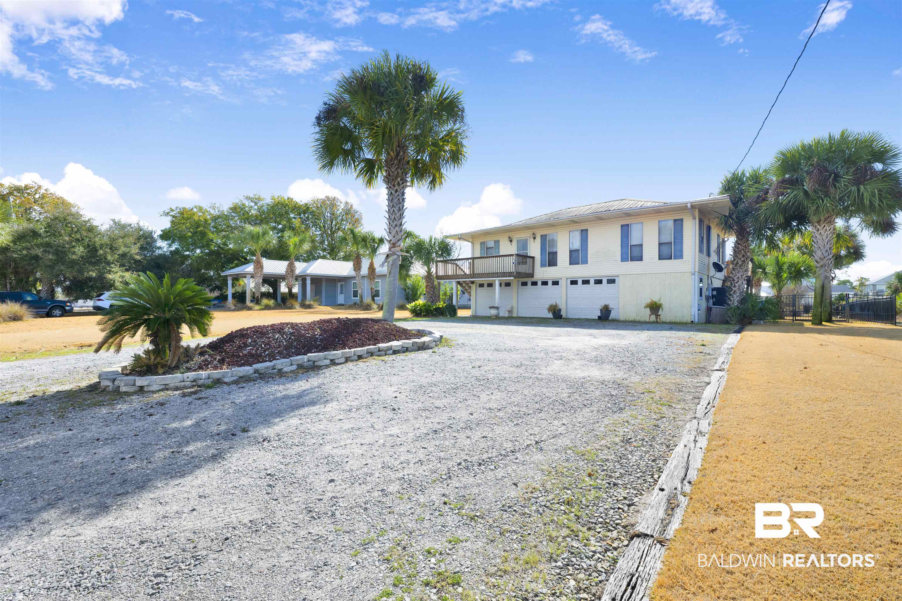 26222 Marina Road Orange Beach, AL 36561 - Photo 13 of 38 View of front facade featuring gravel driveway and a garage