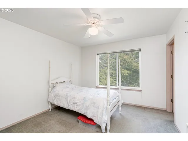 a bedroom with a bed and window