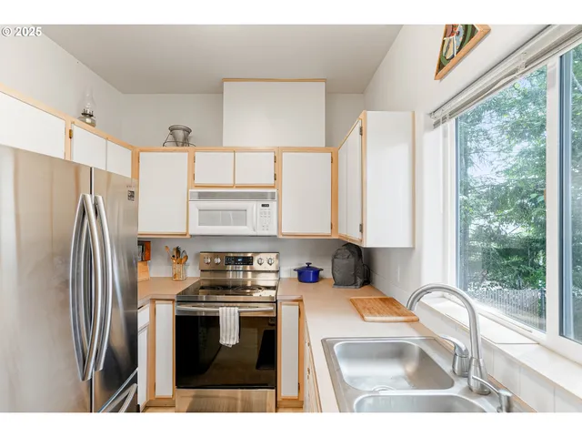 a living room with furniture a chandelier and a window