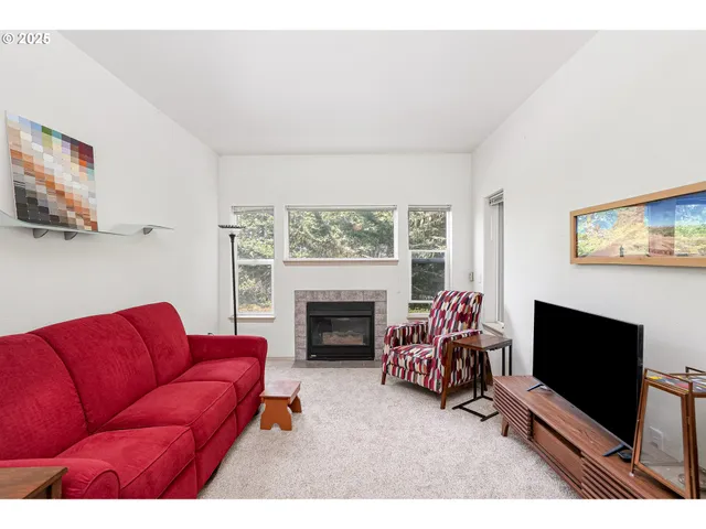 a living room with furniture fireplace and window