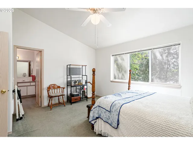a bedroom with a bed chairs and chandelier