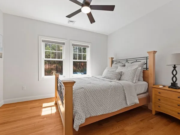a bedroom with a bed and wooden floor