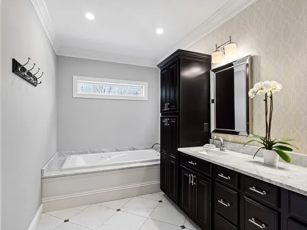 a bathroom with a sink mirror and toilet