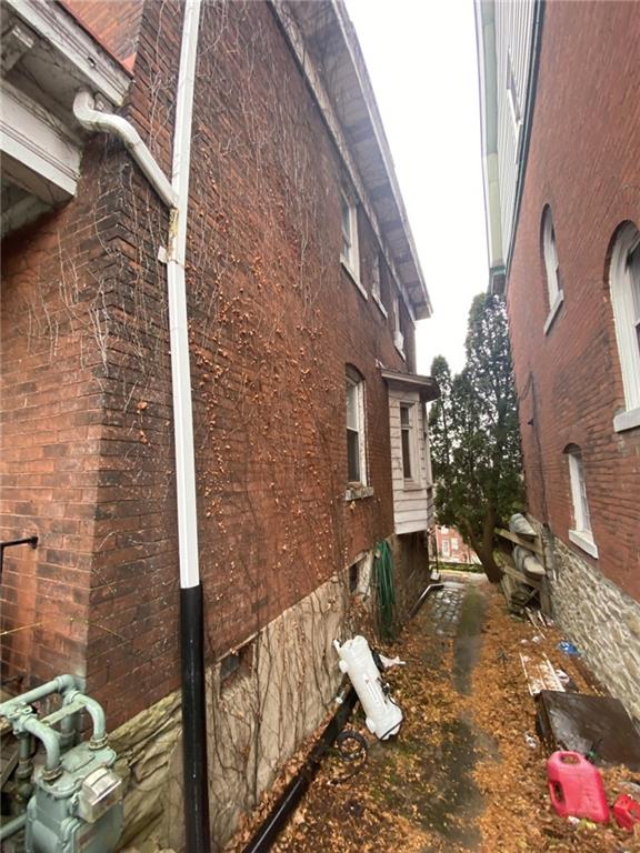 218 McKinley Street Pittsburgh, PA 15210 - Photo 3 of 5 a brick building with a bench in front of it