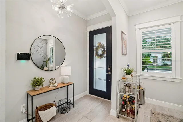 a view of a dining room with furniture and chandelier