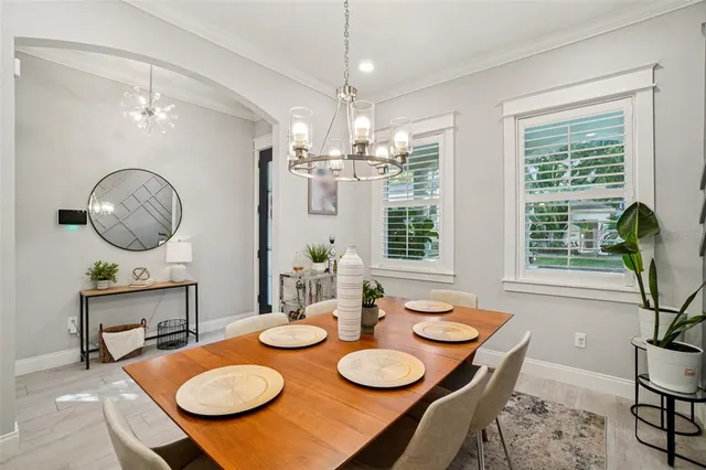 a kitchen with kitchen island granite countertop lots of white cabinets and stainless steel appliances