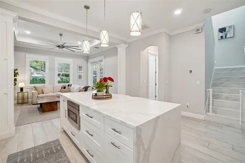 a kitchen with granite countertop a white cabinets sink and stainless steel appliances