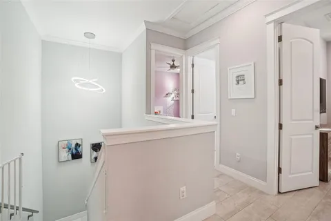 a bedroom with a bed a couch and a flat tv screen on dresser