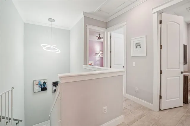 a bedroom with a bed a couch and a flat tv screen on dresser