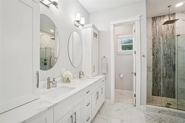 a bathroom with double vanity sinks and a mirror