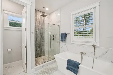 a bedroom with a bed and a flat tv screen on the dresser