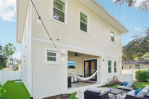a backyard of a house with table and chairs