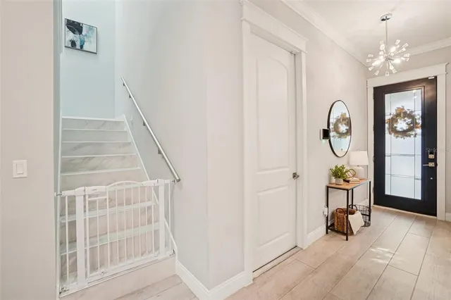 a living room with furniture a large window and a chandelier