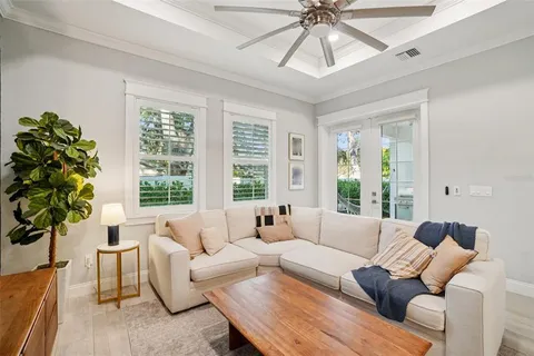 a living room with furniture and kitchen view