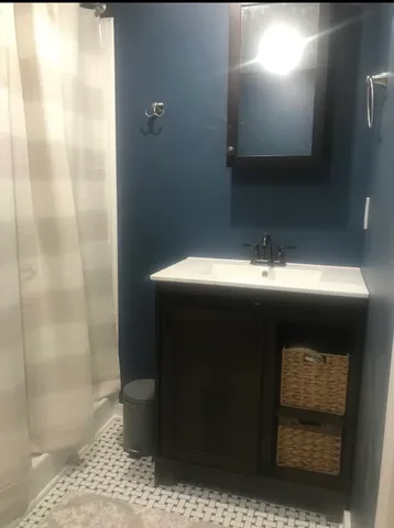 a bathroom with a sink and a mirror