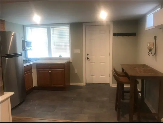 a kitchen with a refrigerator a sink and a stove top oven