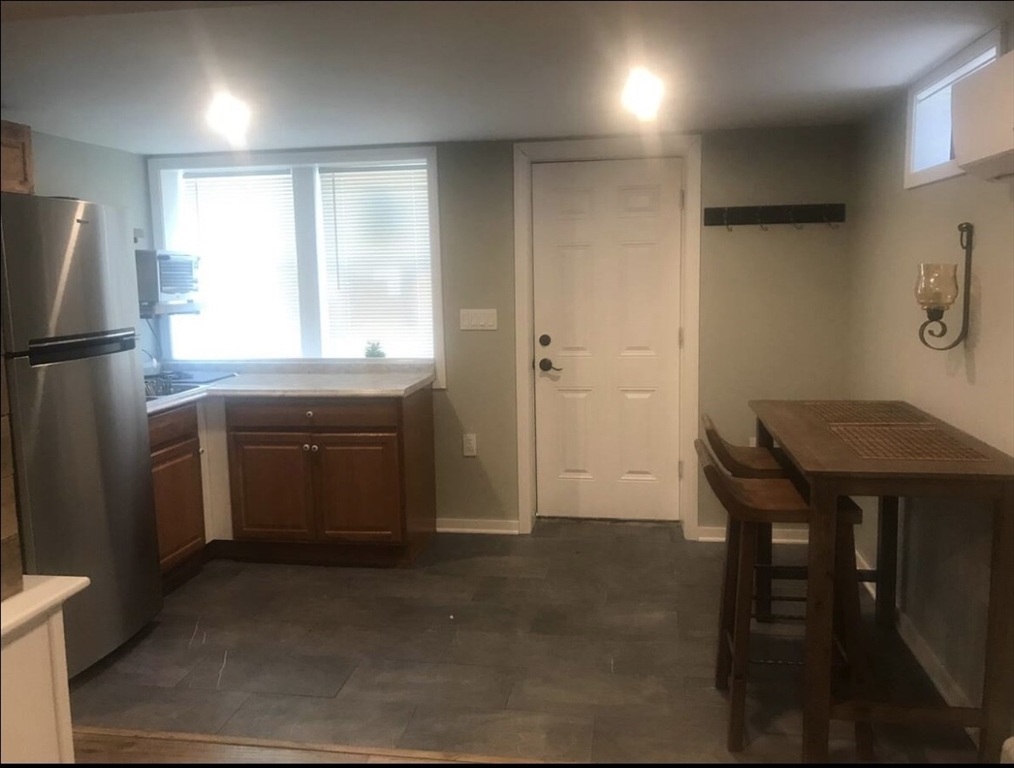 77 Governor Bradford Road, Unit B Brewster, MA 02631 - Photo 3 of 5 a kitchen with a refrigerator a sink and a stove top oven
