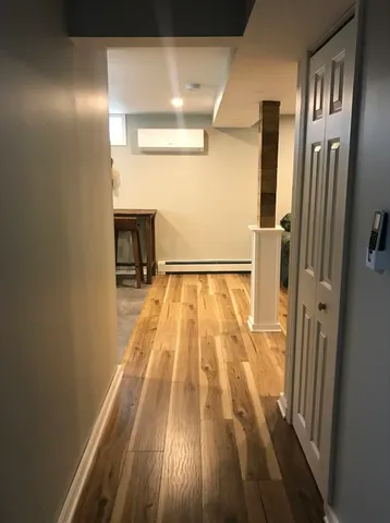 a view of empty room with wooden floor