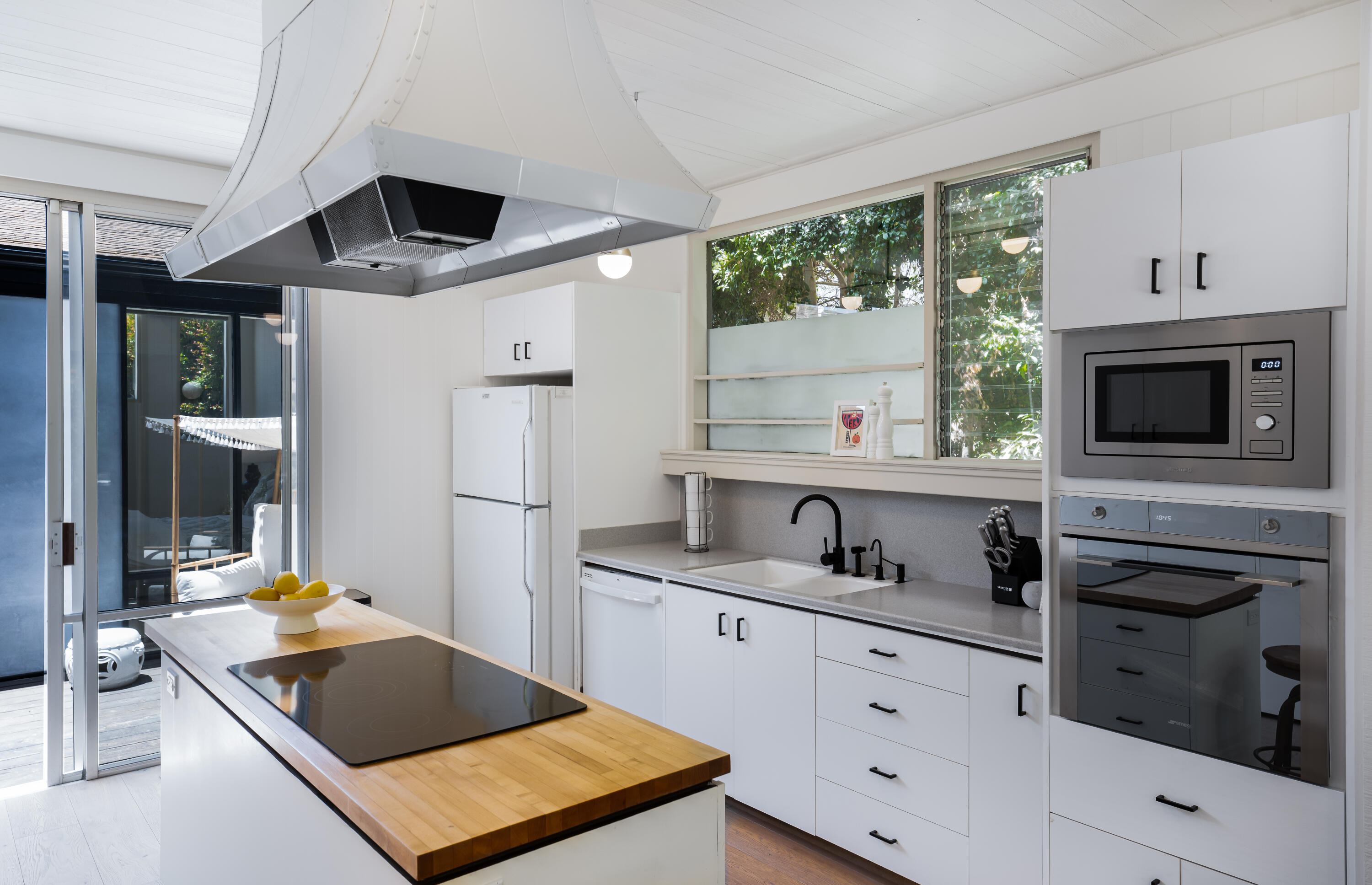 180 Hermosillo Road Montecito, CA 93108 - Photo 14 of 31 a kitchen with a sink a stove and a microwave oven