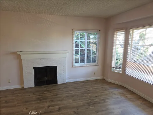a view of an empty room with a fireplace