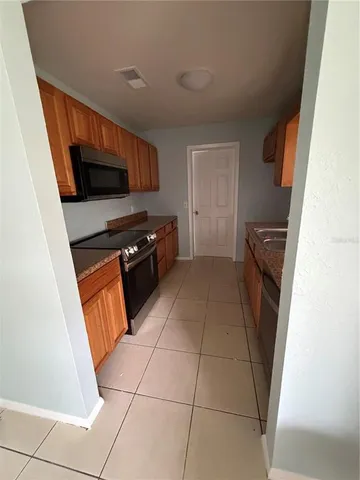 a kitchen with stainless steel appliances a refrigerator and a sink
