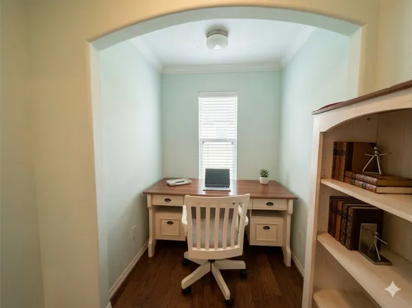 a view of a workspace with furniture and wooden floor