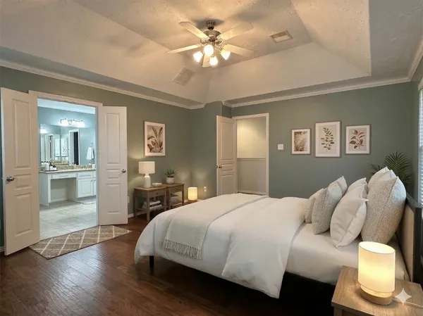 a spacious bedroom with a bed and a chandelier