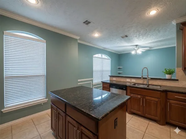 a kitchen with a stove a sink and a refrigerator