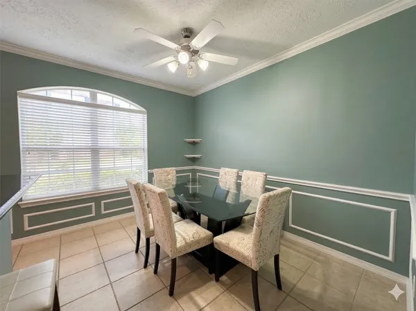 a view of a dining room with furniture and a window