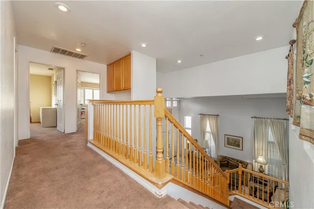 a view of a hallway with a livingroom with furniture