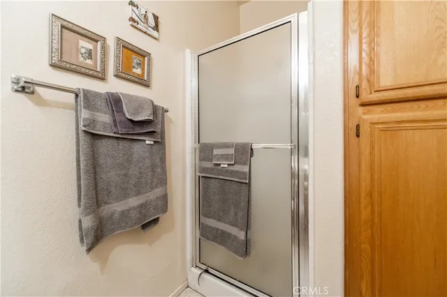 a spacious bathroom with a double vanity sink mirror and shower