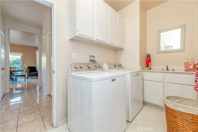 a utility room with sink dryer and washer