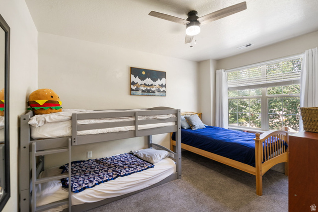 1393 West 150 North Springville, UT 84663 - Photo 16 of 31 Bedroom featuring a ceiling fan, plush carpet flooring, and a large window with white blinds