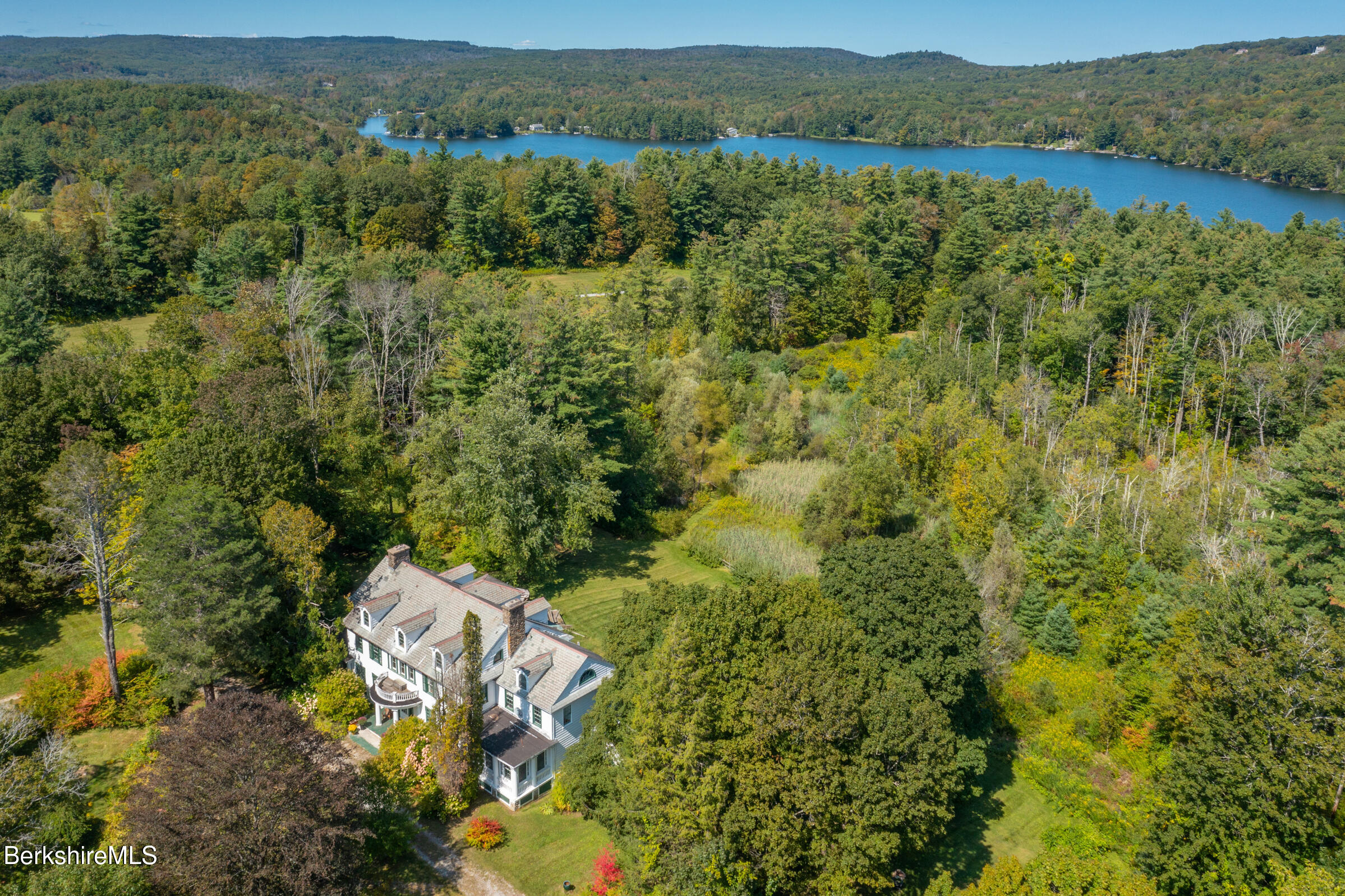 535 Main Road Monterey, MA 01245 - Photo 2 of 45 a view of a forest with a lake