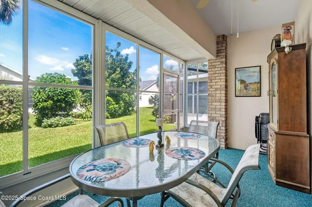 a view of a dining room with furniture window and outside view
