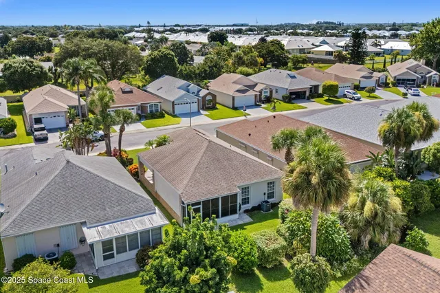 an aerial view of residential houses with outdoor space