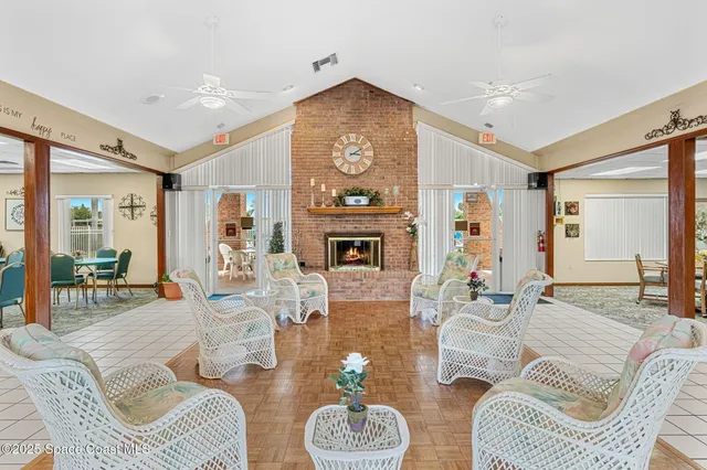 a room with lots of tables a chandelier and living room view