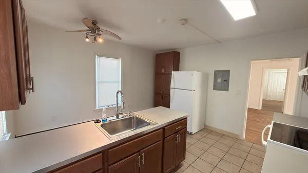 a kitchen with a sink and refrigerator