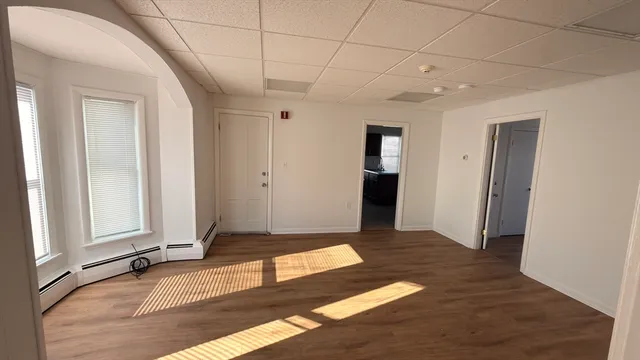 a view of a room with an empty space and window