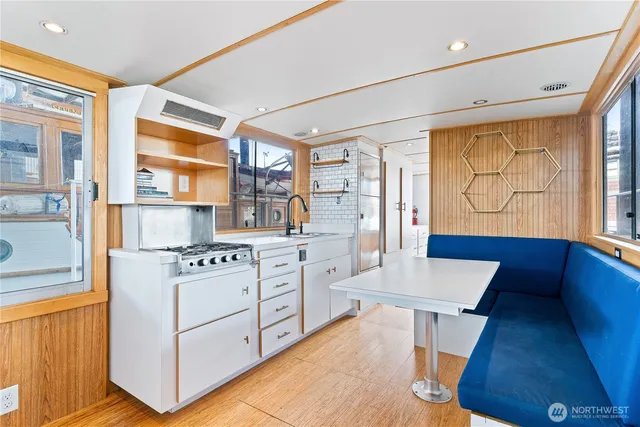 a kitchen with a stove a sink and a refrigerator