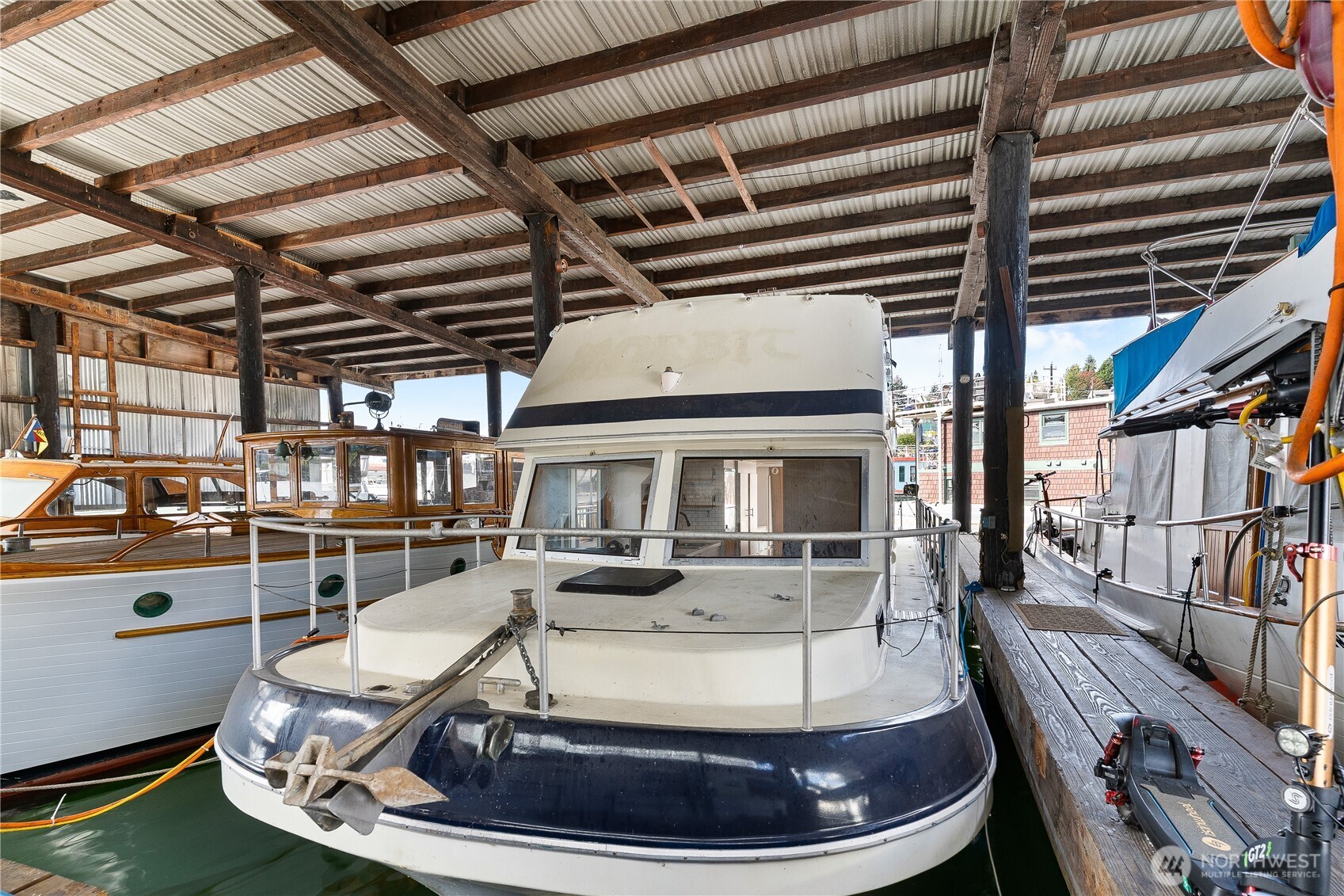 2401 North Northlake Way Seattle, WA 98103 - Photo 15 of 32 a room with lots of wooden furniture and a chandelier