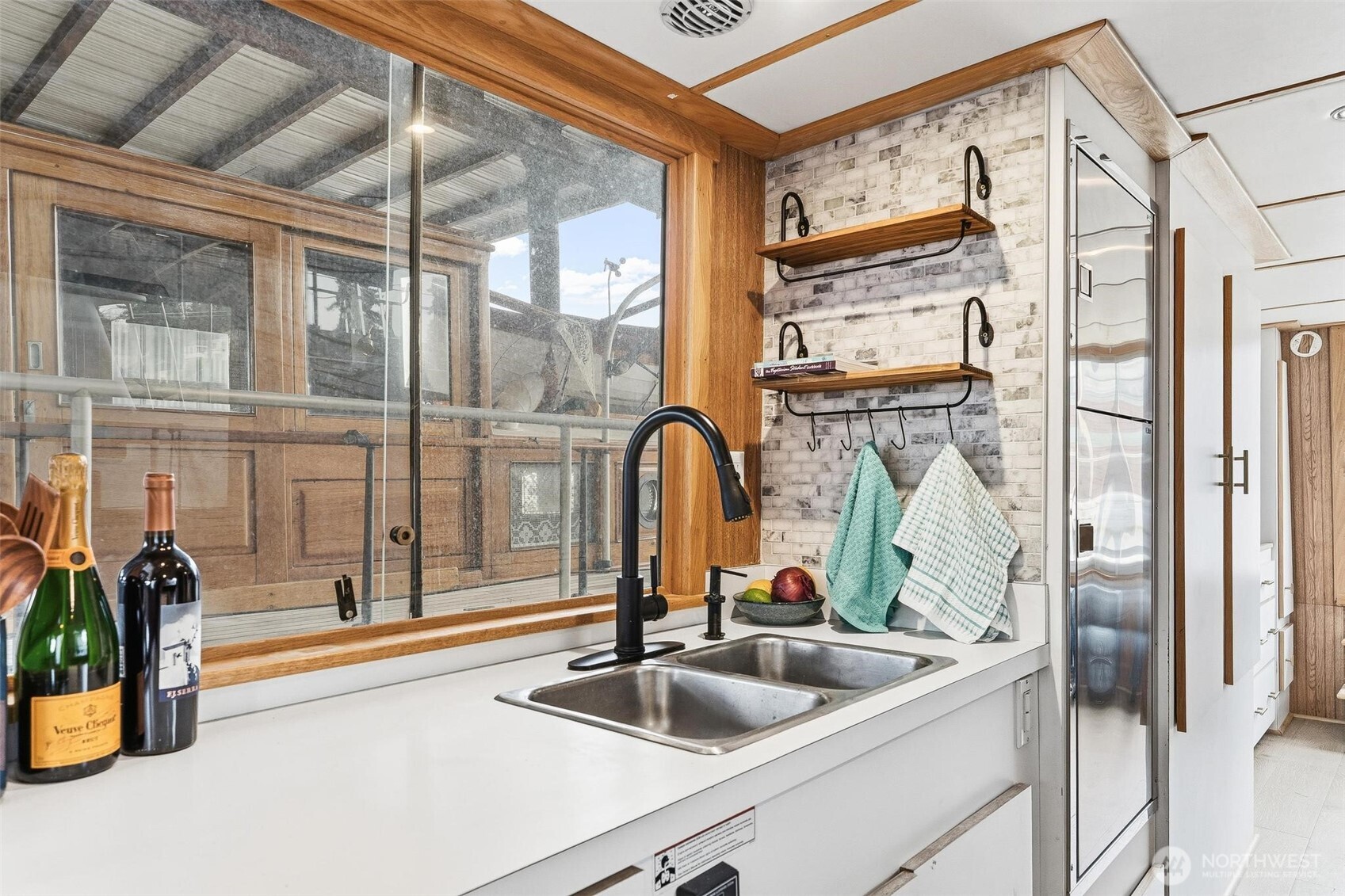 2401 North Northlake Way Seattle, WA 98103 - Photo 2 of 25 a kitchen with a sink and a large window